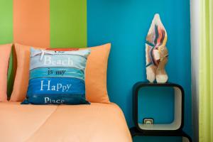 a bed with a pillow and a stuffed rabbit on it at HC Torreira Beach in Torreira +35 photos