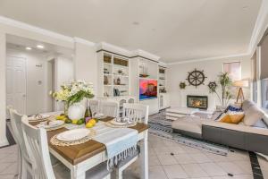 a living room with a table and a couch at A Stunning Beach villa Walking to Huntington Beach in Huntington Beach