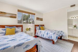 a bedroom with two beds and a window at A Stunning Beach villa Walking to Huntington Beach in Huntington Beach