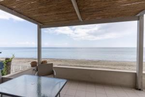 a view of the beach from the porch of a beach house at White Pearl Apartments in Paralia Katerinis