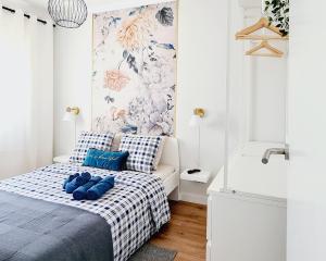 a bedroom with a bed with blue shoes on it at Arrábida Cozy House in Palmela