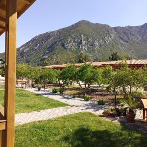 a stone walkway with a mountain in the background at Fidelya Bungalow Evleri in Adrasan