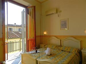a bedroom with a bed and a balcony at Hotel Desirèe in Florence