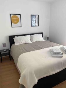 - une chambre avec un grand lit et 2 photos sur le mur dans l'établissement Home Lisbon 1, à Lisbonne