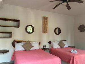 Postel nebo postele na pokoji v ubytování Hotel Diosa del Agua Bacalar