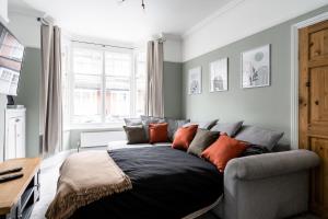 a living room with a bed and a couch at Merton House - Entire Modern City Centre Home in Leicester