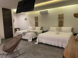 Postel nebo postele na pokoji v ubytování Hotel Diosa del Agua Bacalar