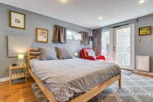 a bedroom with a large bed and a red chair at Platt Park Studio with Patio Walkable Location! in Denver