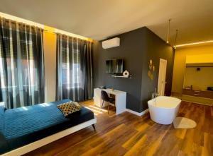 モンテフィアスコーネにあるPalazzo Frigoのベッドルーム1室(ベッド1台、バスタブ、デスク付)