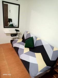 a couch sitting in a room with a mirror at Dreamy 2BR condo, with a golf course view in Cebu City