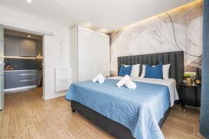a bedroom with a large bed with blue sheets at Apartment Lokva Rogoznica 2973a in Lokva Rogoznica