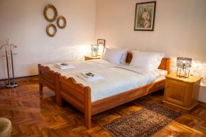 a bedroom with a large bed with two night stands at Petrov konak - apartman Petar in Kučevo