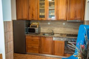 a kitchen with a stainless steel refrigerator and a microwave at Petrov konak - apartman Petar in Kučevo