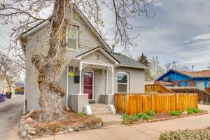a white house with a tree in front of it at 2 Mi to Washington Park Convenient Denver Home! in Denver