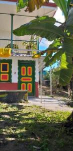 a building with a colorful in a yard at Hostal Casa de Los Taitas in Salento
