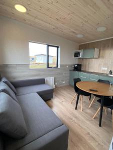 a living room with a couch and a table at Brekkukot Cottages, Blönduós in Blönduós