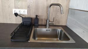 a kitchen counter with a sink and aaucet at Brekkukot Cottages, Blönduós in Blönduós