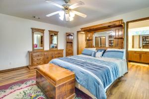 a bedroom with a bed and a ceiling fan at Gassville Home 3 Mi to White River and Trout Fishing in Gassville