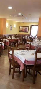 a dining room with tables and chairs in a restaurant at EL RINCON DE TOÑO in Pomar