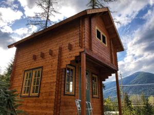 a small wooden house with a roof at Boho Bungalow in Nelson