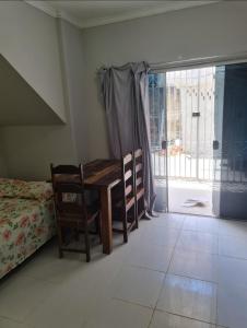 a room with a table and a bed and a window at Residencial Dom Álec S3 in Belém +17 photos
