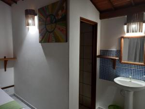 a bathroom with a sink and a mirror at Pousada do farol in Jericoacoara