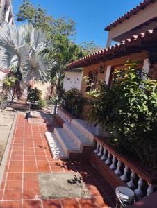 a house with a brick walkway next to a building at Cabaña dulce sueños in Taganga