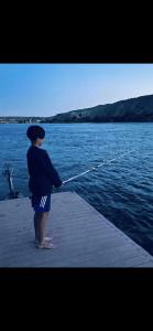 a woman standing on a dock holding a rope at River view Lazy Casa in Bullhead City