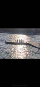 a group of people in a row boat on the water at River view Lazy Casa in Bullhead City