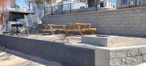 a wooden picnic table sitting next to a brick wall at River view Lazy Casa in Bullhead City