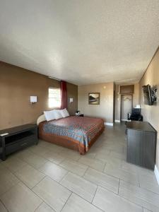 a hotel room with a bed and a television at Sunset Inn Historic District St. - St. Augustine in St. Augustine