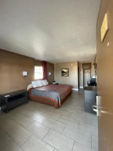a large hotel room with a bed and a kitchen at Sunset Inn Historic District St. - St. Augustine in St. Augustine +1 photo