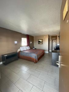 a hotel room with a bed and a bathroom at Sunset Inn Historic District St. - St. Augustine in St. Augustine