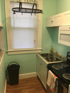a kitchen with a sink and a stove and a window at Cozy Bay View OceanSide cottage in Willoughby Beach