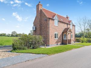 an old brick house with a road in front of it at Horseshoe Cottage in Cottam