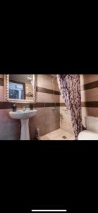 a bathroom with a sink and a toilet and a mirror at Blue Hotel boutique in Selínia