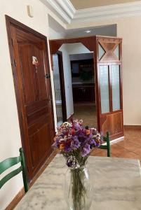 a vase filled with flowers sitting on a table at Appartement propre et calme in Casablanca