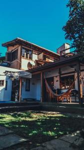 a building with a hammock in front of it at Casa grande,3 min a pé do Centro, grupos, familias in Paraty