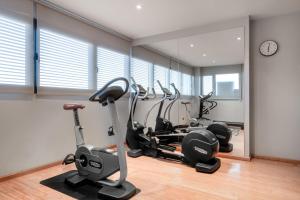 un gimnasio con cintas de correr y bicicletas estáticas en una habitación en AC Hotel Alcalá de Henares by Marriott, en Alcalá de Henares