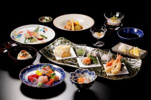 a table with plates of food on a table at Hotel Nikko Kanazawa in Kanazawa