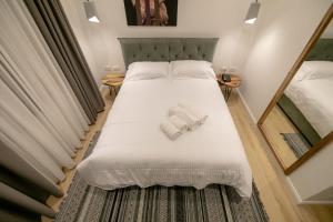 a bedroom with a bed with two towels on it at Elegance Boutique Hotel in Korçë