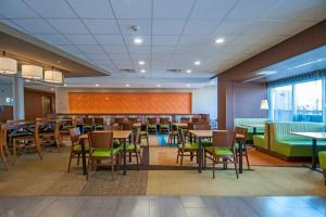 a dining room with tables and chairs in a cafeteria at Fairfield Inn & Suites by Marriott Dallas Plano North in Plano