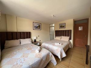 A bed or beds in a room at Antara Hostal