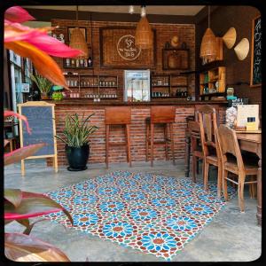 a bar with a blue and white rug on the floor at The Happy Bird B&B in Hoi An
