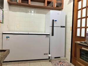 a white refrigerator and freezer in a kitchen at Casa Aurora Luz do Amanhecer in Rio de Janeiro