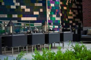 a group of tables and chairs in front of a wall at Renaissance Arlington Capital View Hotel in Arlington