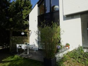 a backyard deck with two chairs and a table at Apartment Black & White Neuss in Neuss