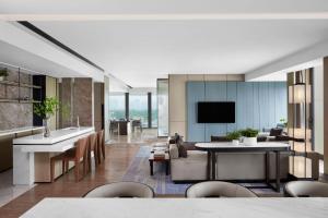 a kitchen and living room with a couch and a table at JW Marriott Shanghai Fengxian in Shanghai