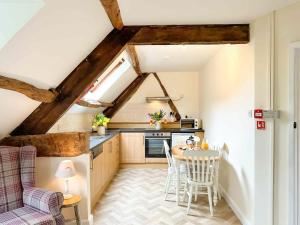 a kitchen with a table and chairs in a room at Kite 2 - Uk6547 in Llanfihangel-Bryn-Pabuan