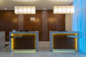 a lobby with two desks and two lights at Guyana Marriott Hotel Georgetown in Georgetown